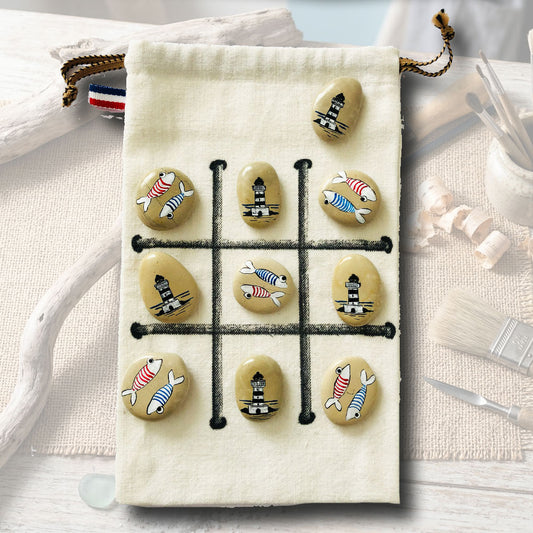 Jeu de morpion artisanal sur galets, motifs poissons à rayures et phares bretons, sachet en toile beige 15x21cm, création L'Atelier du Ressac.